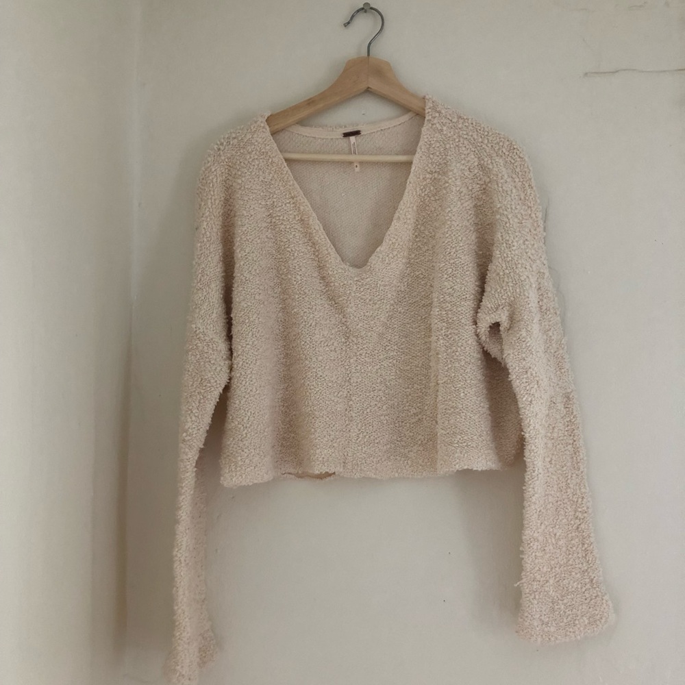 Cream colored free people sweater.